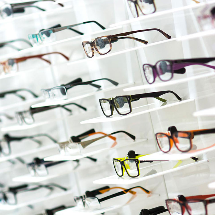 Many pairs of glasses on store shelves