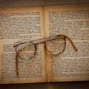 Glasses on top of old book