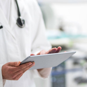 Medical professional holding a tablet