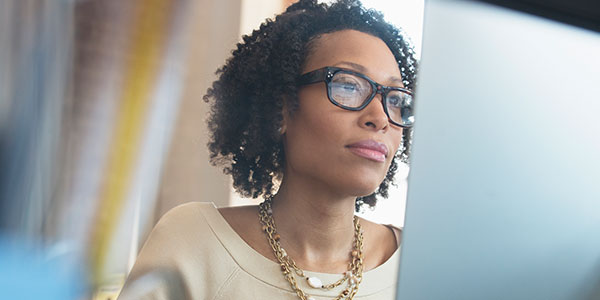 Woman wearing glasses while using a computer