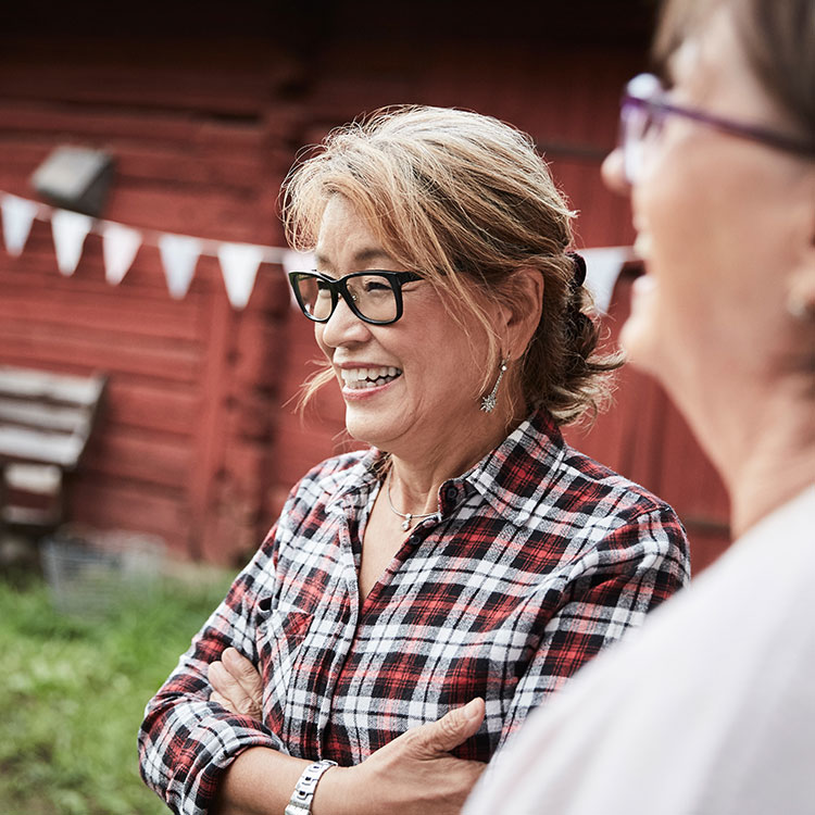 Image of two older women with glasses talking to each other
