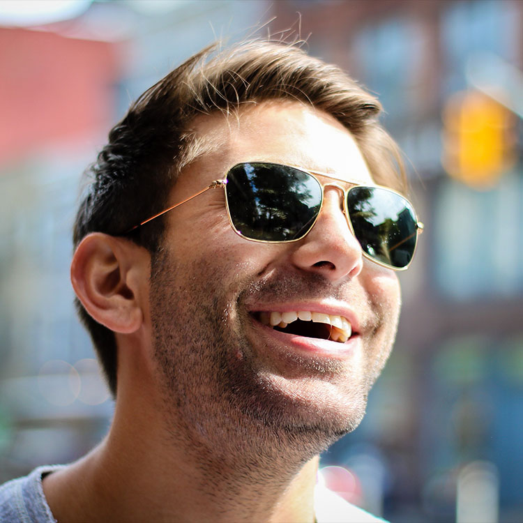 Smiling man wearing sunglasses outdoors