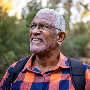Elderly man wearing glasses while hiking