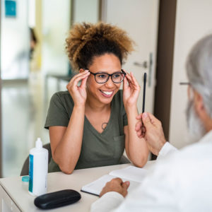 Young woman trying on glasses