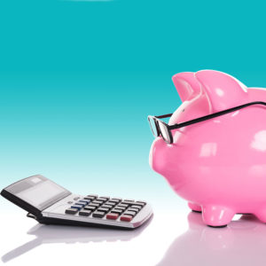 Piggy bank looking at a calculator
