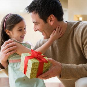 Father giving daughter a present