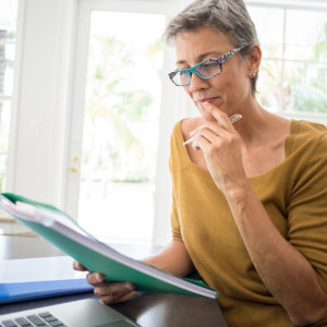 Middle-aged woman looking at paperwork