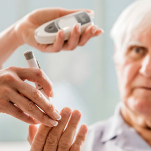 Older man checking blood sugar