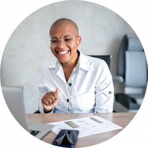 african american female doctor sitting at her desk and smiling